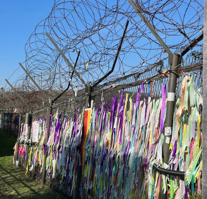 Prayer ribbons tied to a barbed wire fence near Freedom Bridge. Picture: Kristie Kellahan