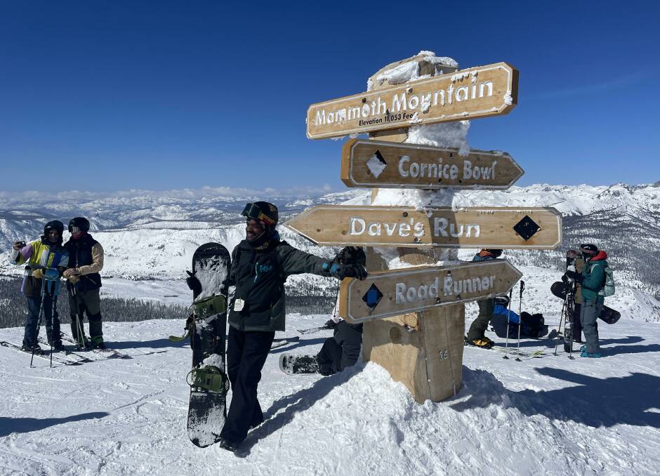 A boarder poses for a pic at the summit. This sign is actually 5.5m tall, the rest is under snow.
Picture: Scott Hannaford