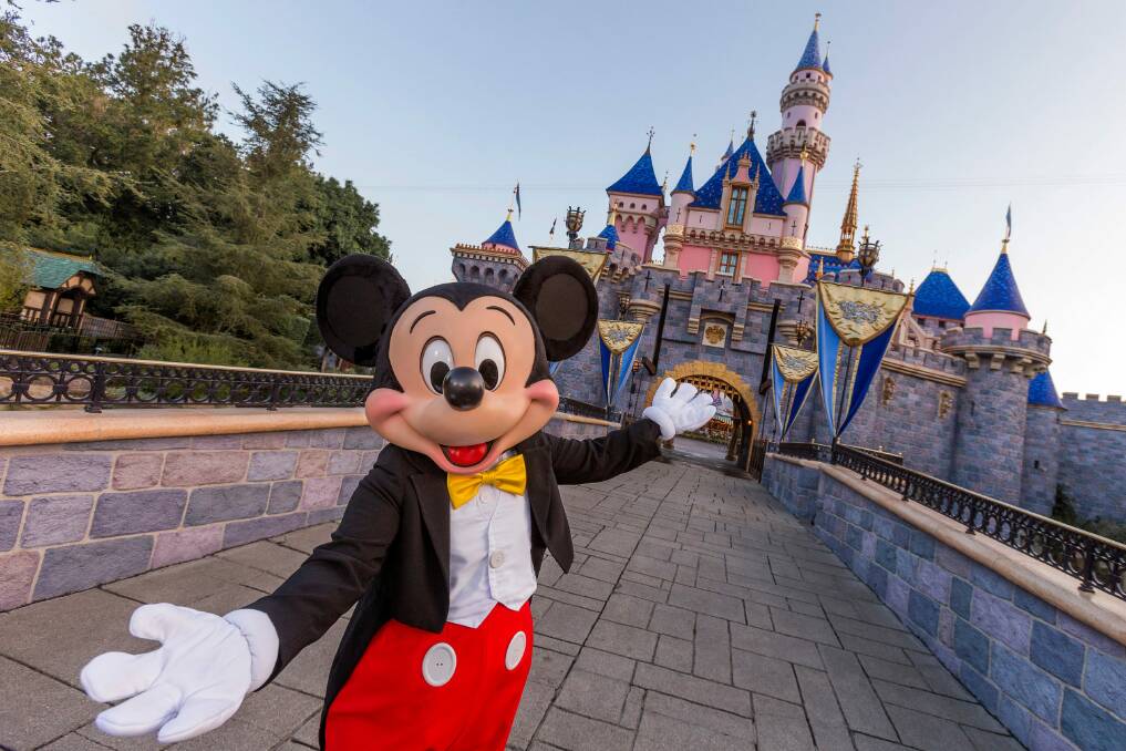Mickey Mouse poses in front of Sleeping Beauty Castle at Disneyland in California. Picture: Getty Images