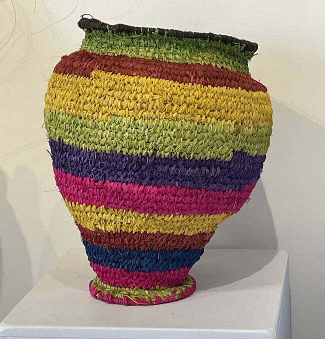 A colourful striped urn for sale. 
