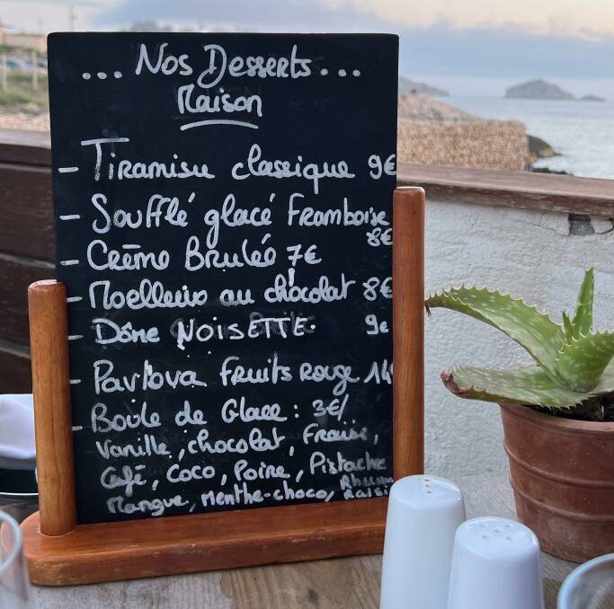A chalkboard advertises the day's desserts. Picture: Kristie Kellahan