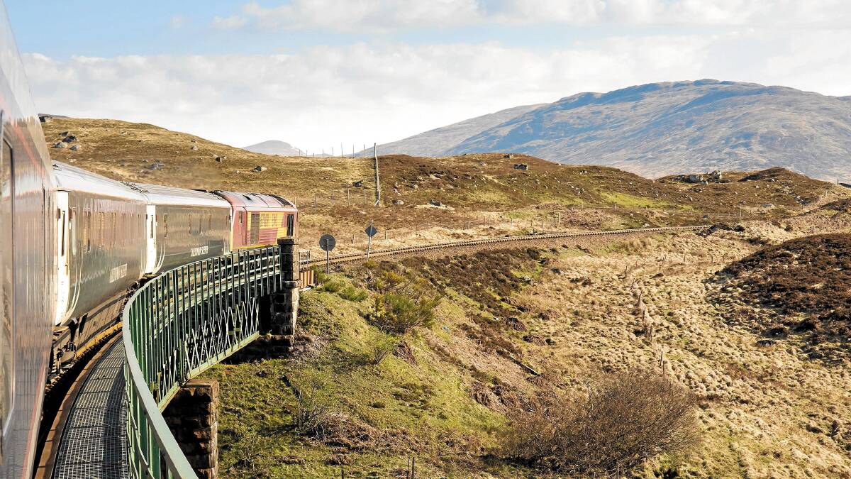 The Caledonian Sleeper crosses Rannoch viaduct in the Scottish Highlands