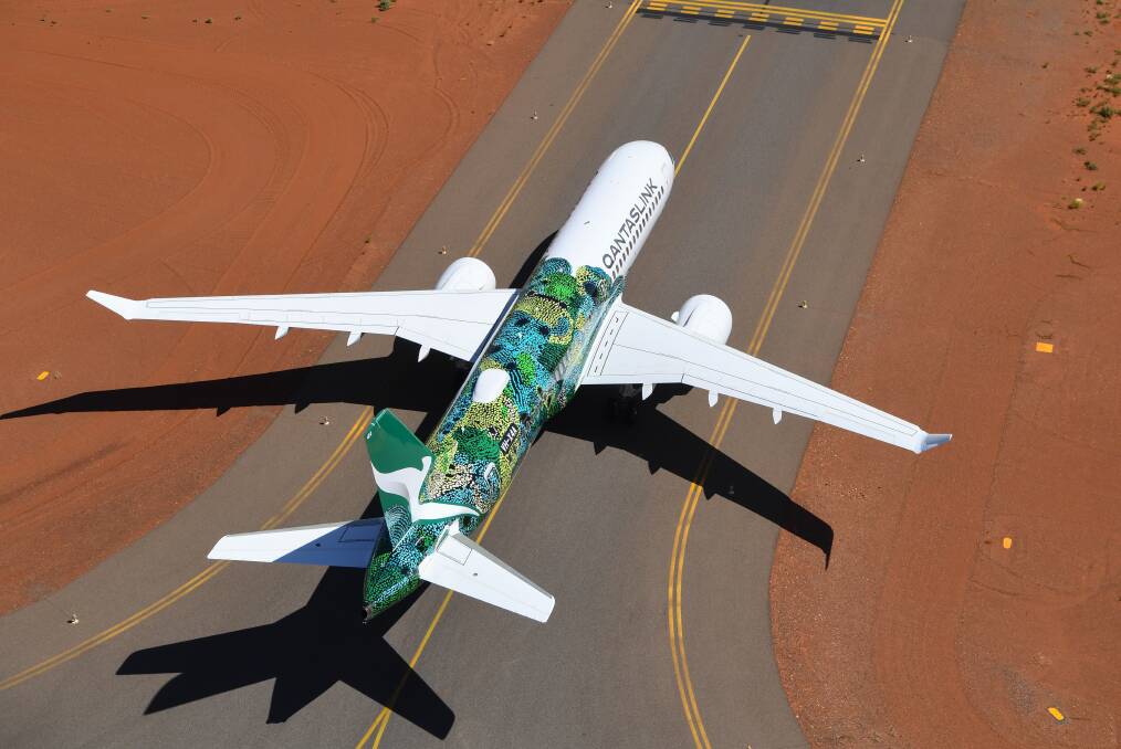 The A220-300, with the artwork Minyma Kutjara Tjukurpa, on the runway at Uluru.