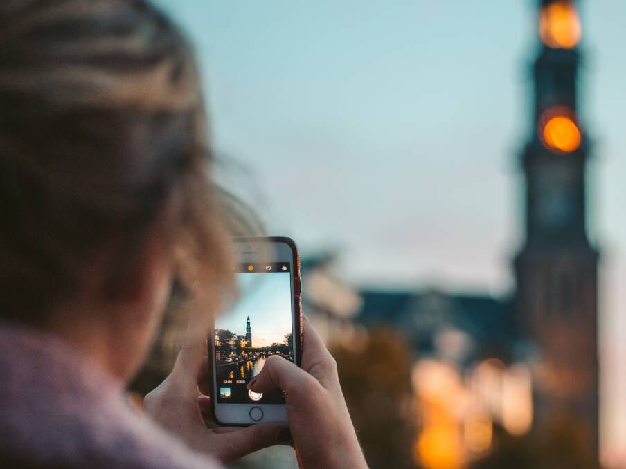 A traveller taking a photo. Picture: Unsplash