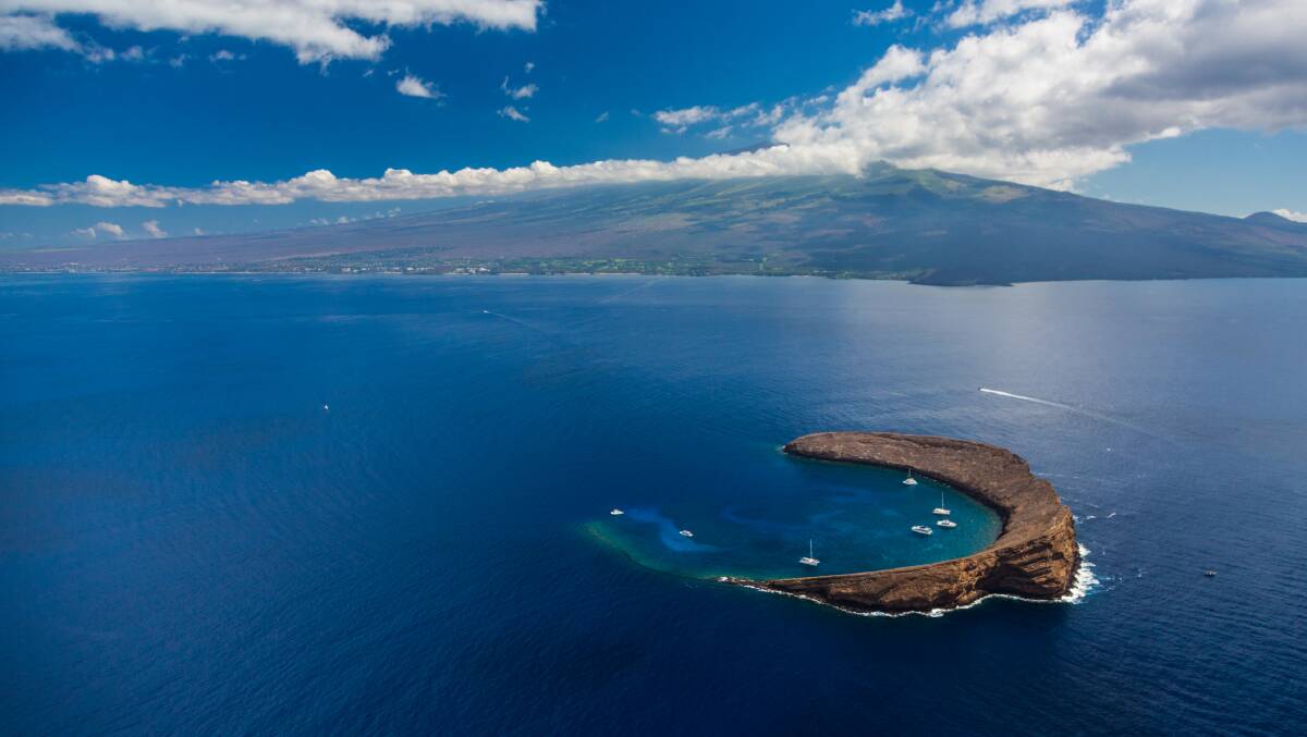 Molokini crater with the Maui coastline in the distance. 