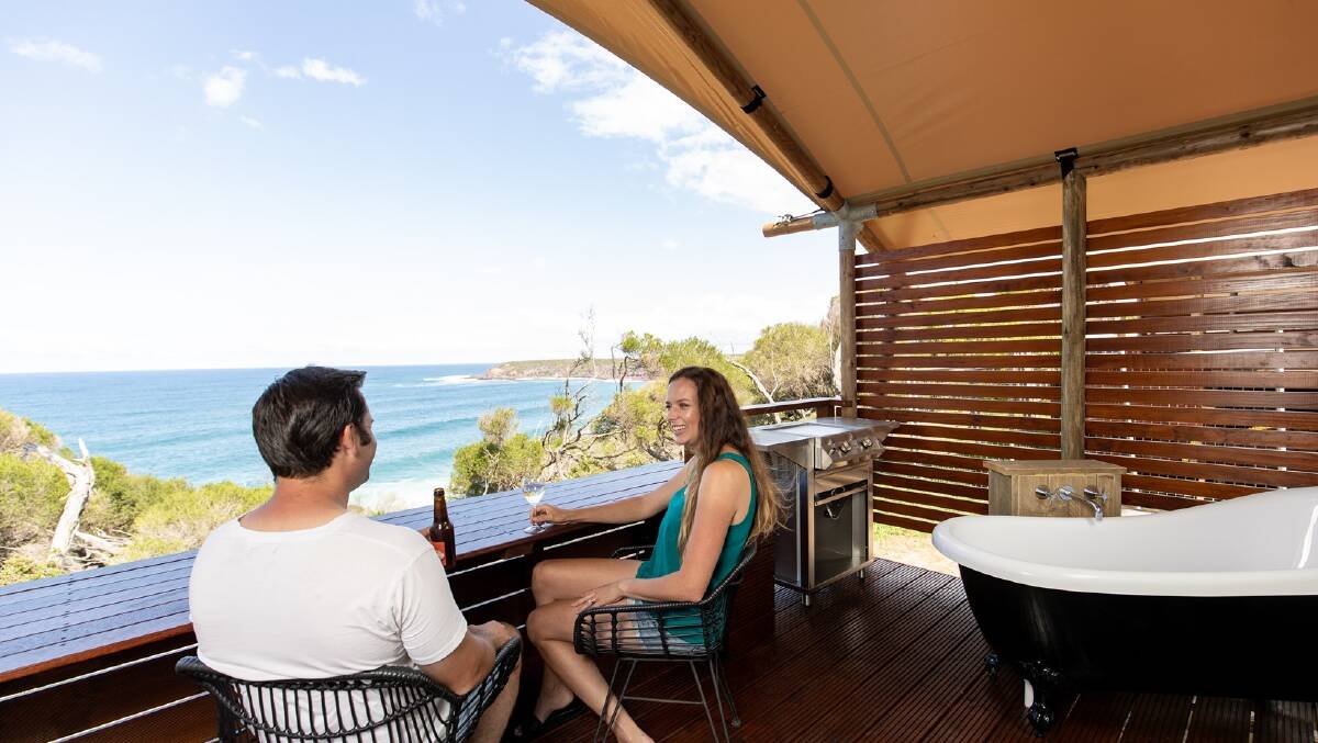 The private verandahs feature a built-in bar/dining area and even a bath where you can laze while you look out for whales. Picture: Destination NSW
