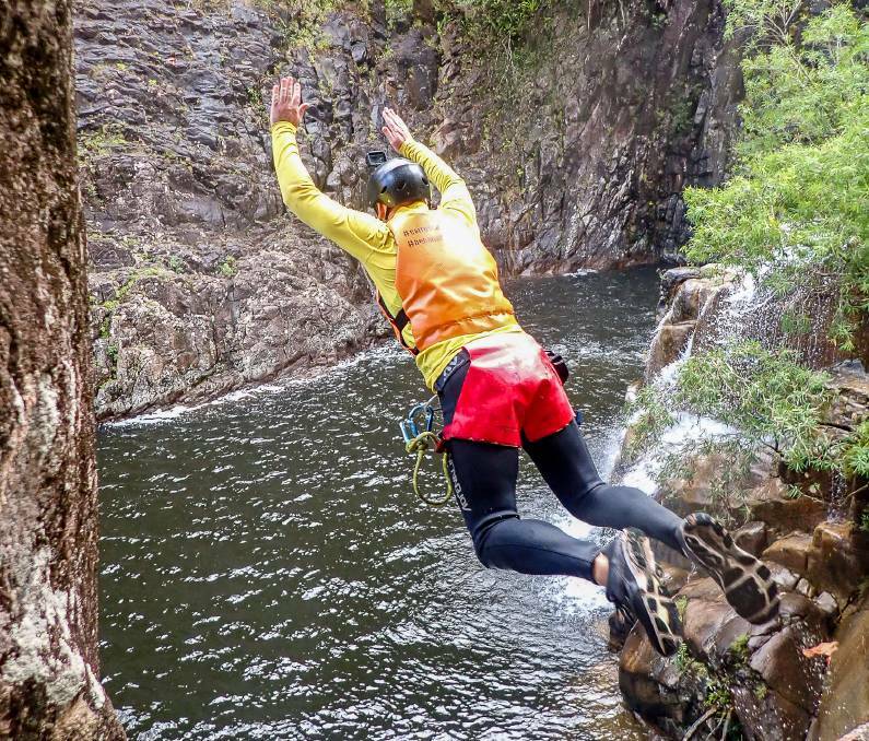 After some encouragement, Michael Turtle jumps into Behana Canyon. Picture- Dominic Godwin.