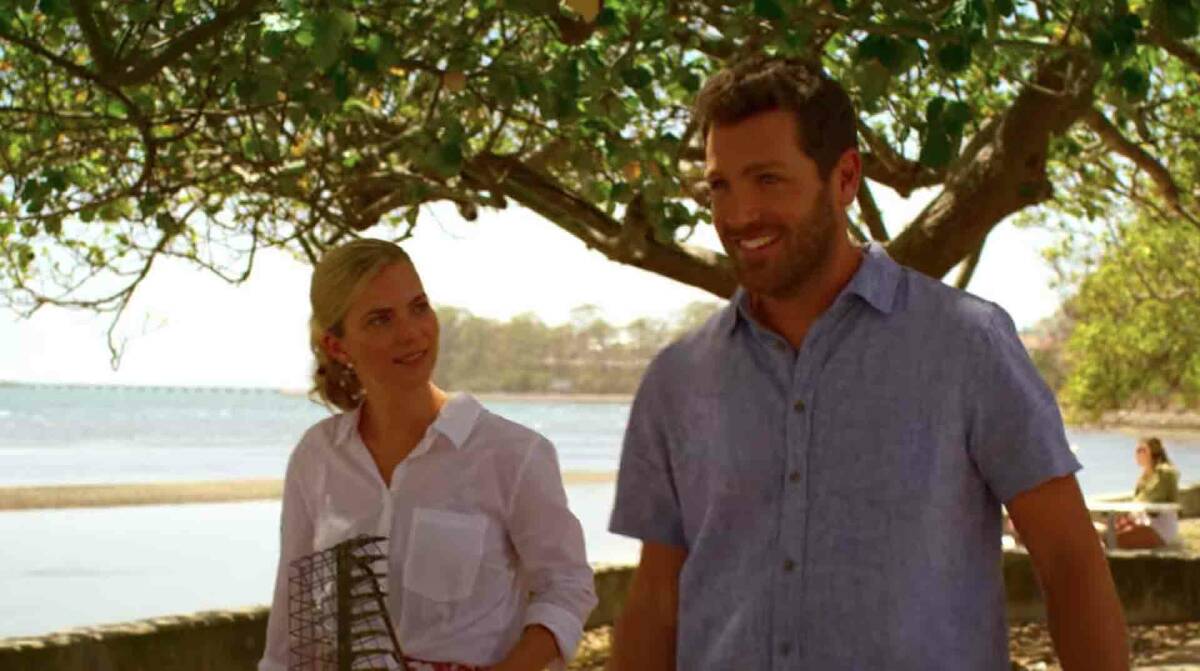 Simon and Caroline taking a stroll along the foreshore in the movie.